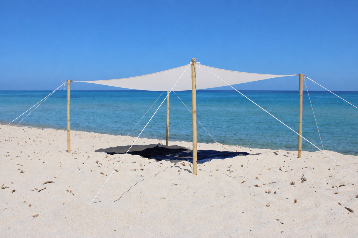 MALITI Portable Beach Sun Sail with natural bamboo poles on a Mediterranean beach