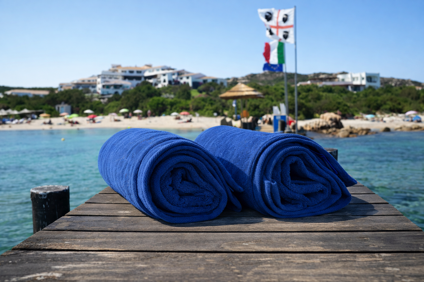 Two blue towels on the wooden dock of the luxury Hotel Romazzino